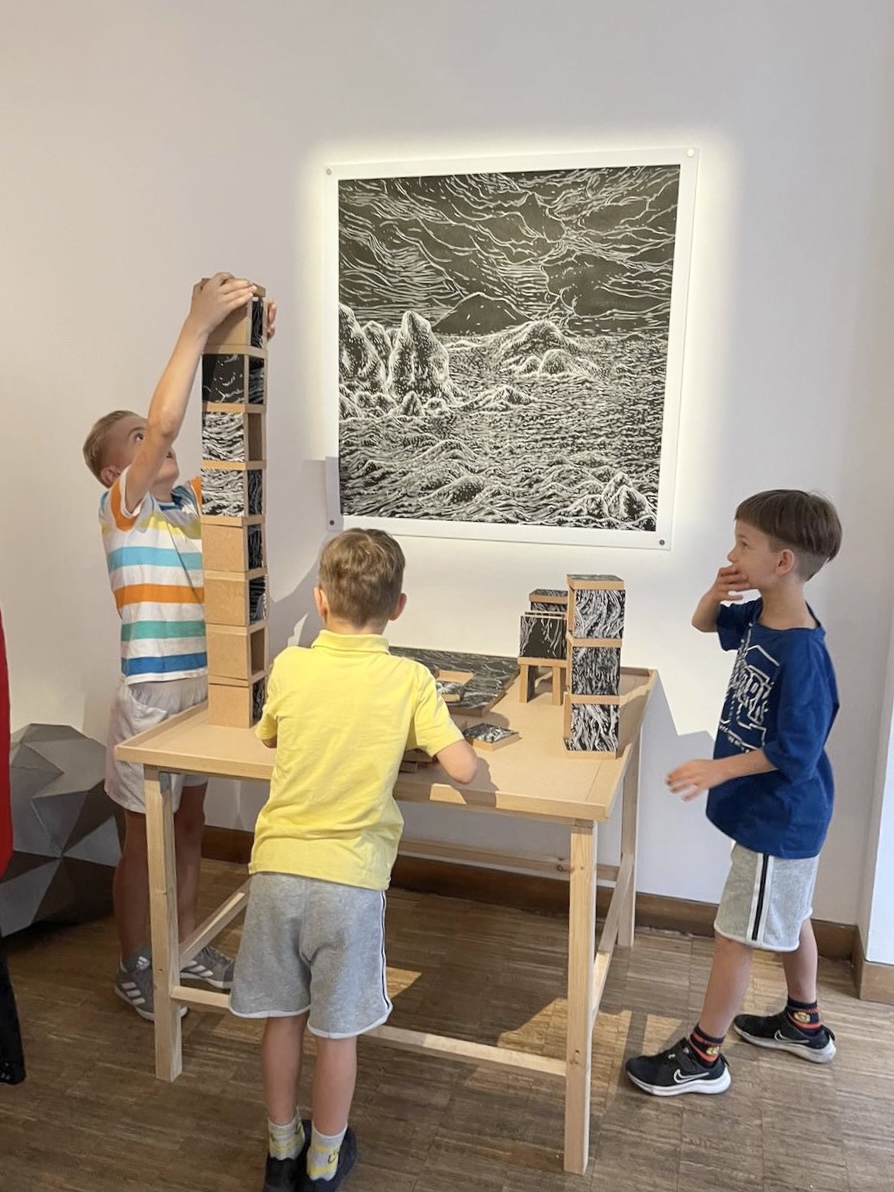 Children playing with The Cosmic Landscape Puzzle at The Muse Gallery